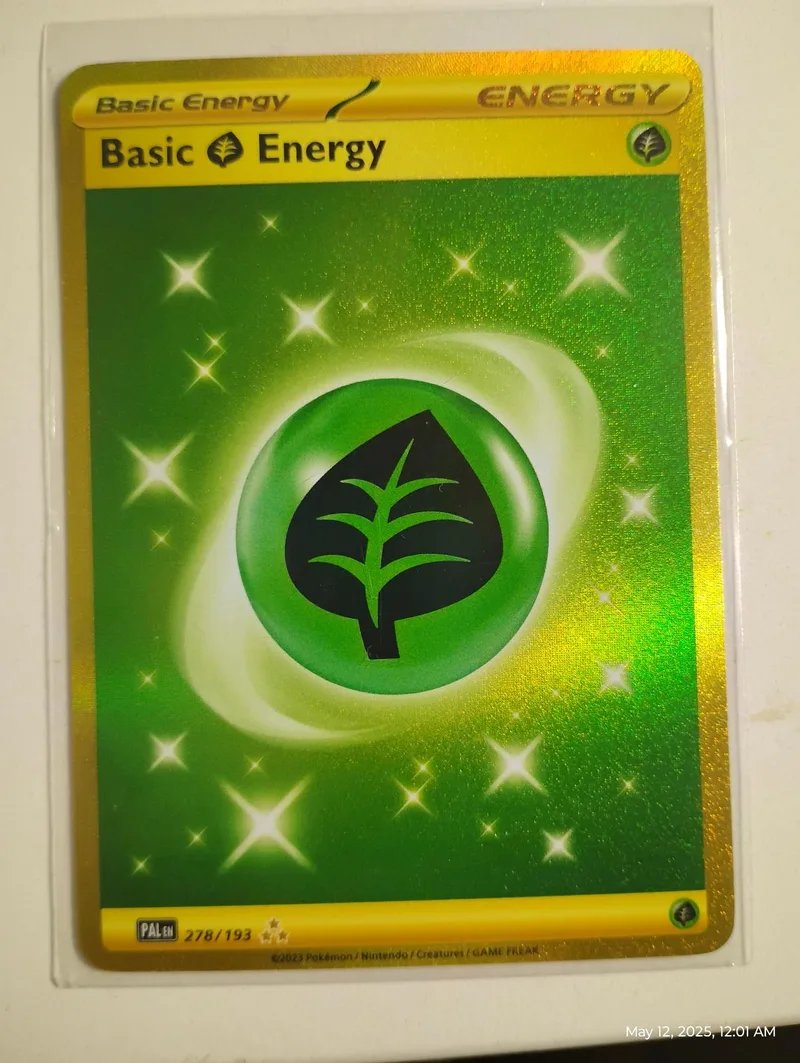 Green and gold Pokémon card featuring a black leaf design in a protective sleeve.