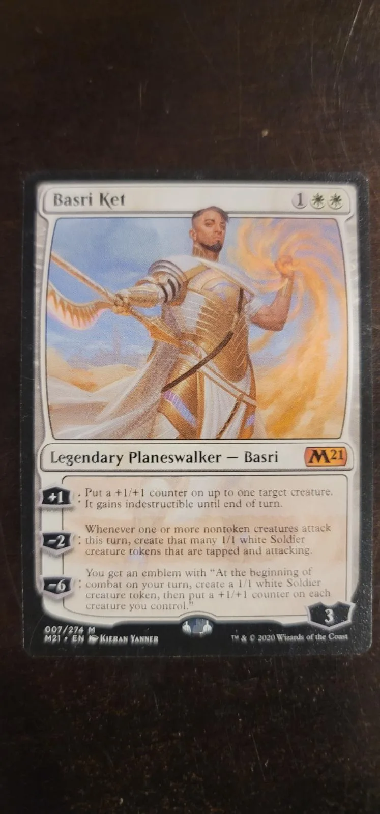 Card featuring a warrior figure in gold armor against a yellow background.