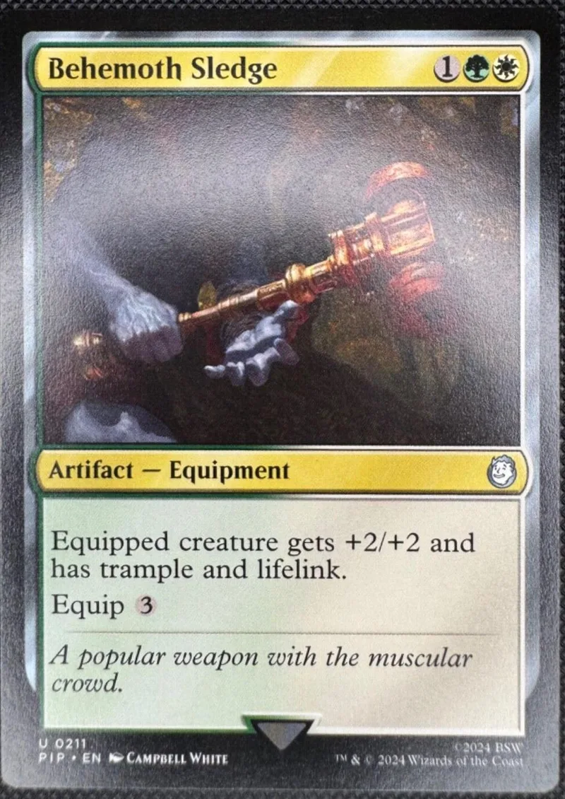 Behemoth Sledge Magic: The Gathering card, gold and black artwork.