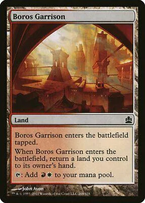 Card art depicts a fiery, industrial landscape. Boros Garrison land card.