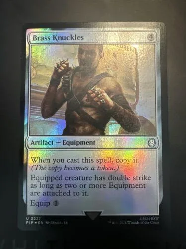 Card art shows muscular figure with brass knuckles. Silver and gold accents.