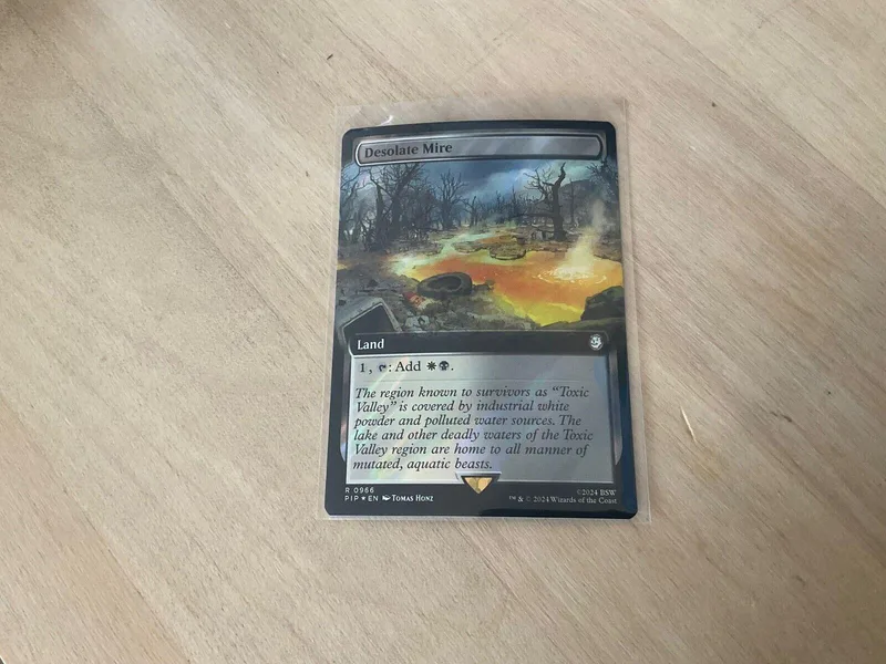 Magic: The Gathering card, Desolate Mire, land type, dark swamp artwork.