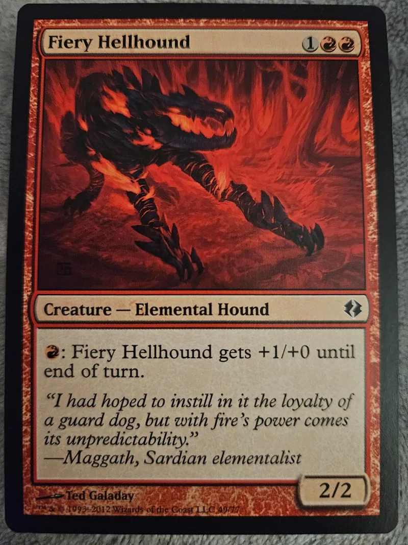 Black and red card art of a fiery, dark hound creature.