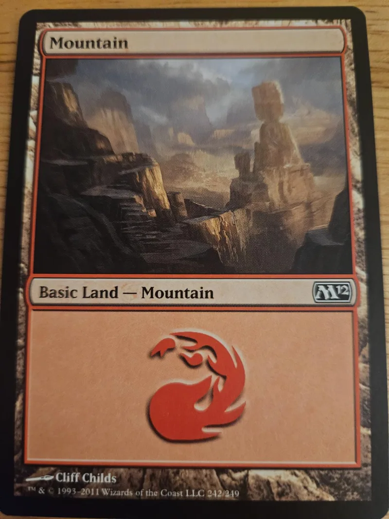 Mountain land card art showing rugged, rocky landscape. Basic land type.