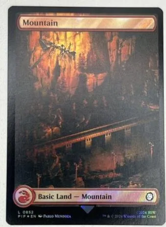 Mountain land card art showing a bridge over a dark, rocky landscape.
