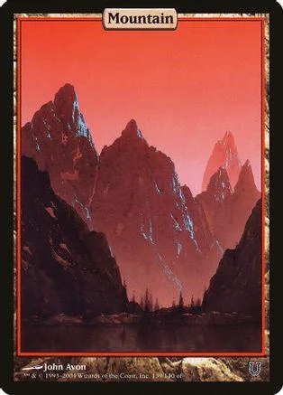 Red and dark mountains over water on a collectible card.
