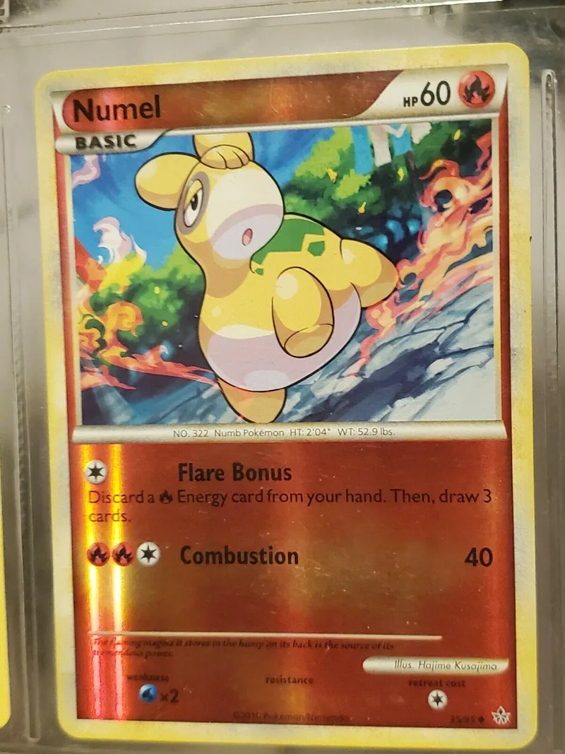 Yellow Pokémon card featuring a cheerful creature against a fiery, green background.