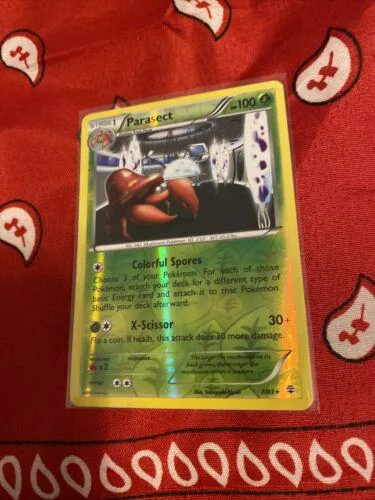 Pokémon card: Parasect, colorful spores attack, green and black design.