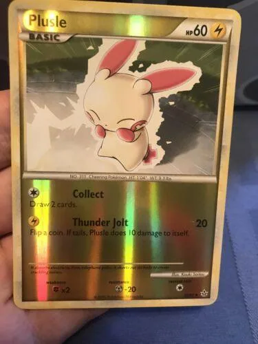 White and pink cartoon creature on a gold-bordered trading card.