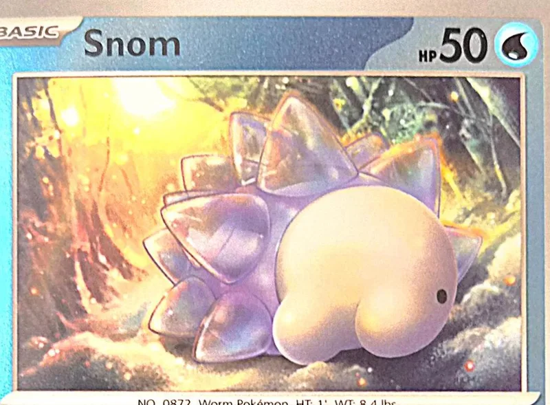 Purple and white Pokémon card featuring a round, spiky creature in a bright forest.