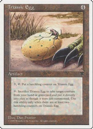 Yellow speckled egg on dirt, with two dark, curved objects nearby.