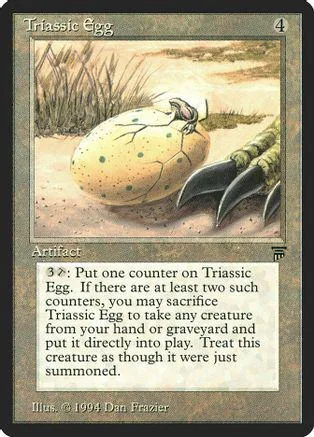 Yellow speckled egg on sandy ground, fantasy art card with text box.
