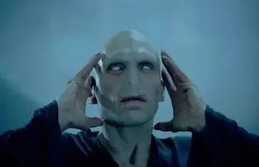 Pale, bald figure with hands on head against a light blue background.