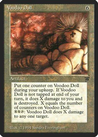 Card art depicts a tribal figure in a dark, reddish setting. "Voodoo Doll" card.